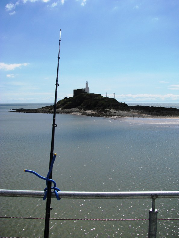 Fishing Off Mumbles Pier With Lighthouse